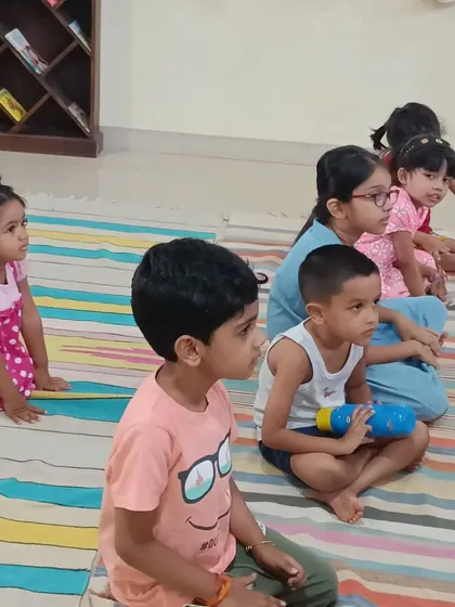 The children are all sitting upright and paying close attention, a testament to the storyteller's skill.