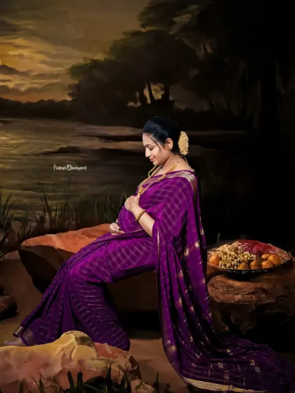 A dreamy, moonlit scene for a beautiful mom-to-be. This artistic studio portrait in a lovely purple saree has a magical, storybook feel.