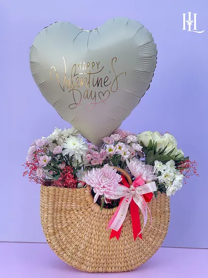 A hamper that adds magic to your Valentine's Day. This charming jute bag is filled with fresh flowers and topped with a "Happy Valentine's Day" balloon.
