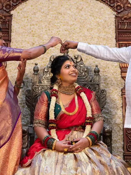 A heartwarming moment as the bride is blessed by her parents during a traditional ceremony.
