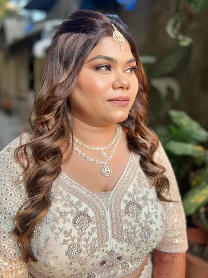 A side profile of this glamorous look, highlighting the soft curls and defined cheekbones.