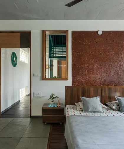In this bedroom, I included internal windows that overlook the double-height living area. This feature allows for visual connection and shared light while maintaining the privacy of the room.
