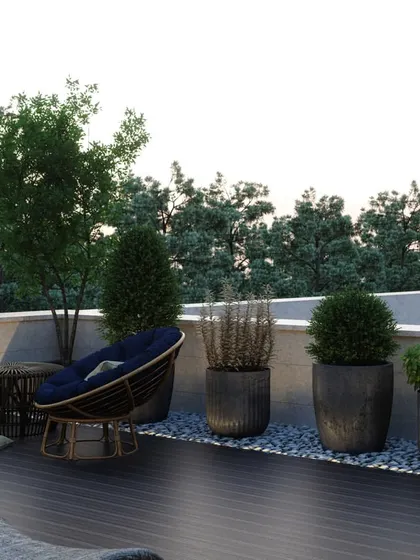 A relaxing corner on the terrace with comfortable seating and a variety of potted plants, offering a peaceful view of the surrounding greenery.