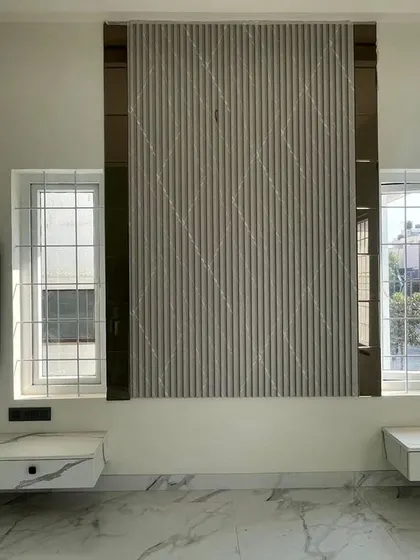 Another angle of the bedroom under construction, showing the relationship between the fluted wall panel, windows, and the floating vanity units.