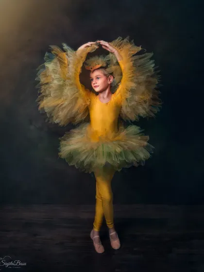 As a trained classical dancer myself, I was thrilled to photograph this young ballerina. Her pose, reminiscent of the goddess Saraswati, creates a beautiful fusion of cultures and art forms.