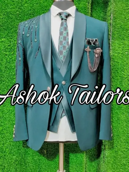A teal suit with peacock-feather inspired embroidery on the shoulder.