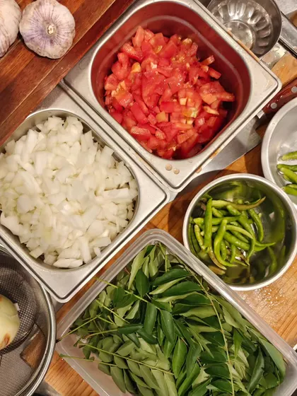 The basic but essential prep for any Indian meal, even in Japan. Freshly chopped onions, tomatoes, curry leaves, and green chillies ready to go.