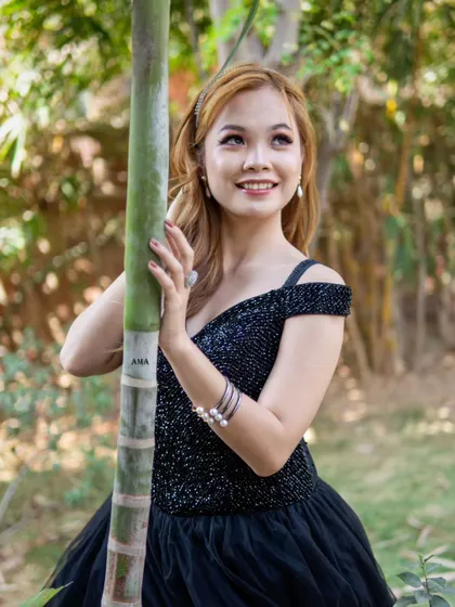 A beautiful portrait showcasing the sequined bodice of this black ballgown, which catches the light perfectly.