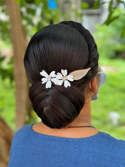 A beautiful and clean low bun created by a student. This style is perfect for learning the fundamentals of creating polished updos.
