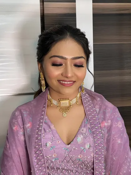 A close-up of the soft purple eyeshadow and glowing skin.