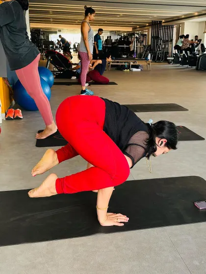Finding my sanctuary in the practice of yoga. Here I am in Bakasana (Crow Pose) at a gym, showing that you can find your moment of focus and strength anywhere.