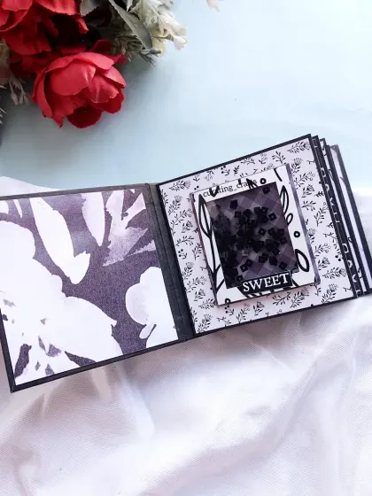 A page with a shaker window, continuing the elegant black and white floral theme.