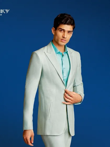 A light mint green suit offers a fresh and modern take on formal wear. We craft our suits to be perfectly tailored, ensuring you radiate sophistication.