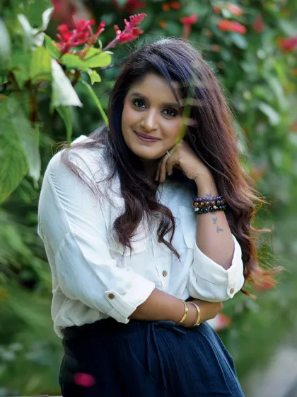A lovely outdoor portrait of a woman with a gentle smile, surrounded by nature. These sessions are all about capturing your natural beauty.
