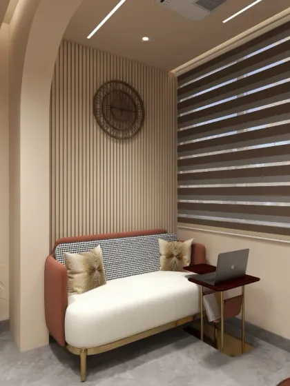The lounge area within the office provides a comfortable escape, complete with a stylish sofa and a small laptop table for informal work or breaks. The vertically fluted wall panel adds texture and visual interest to this cozy nook.