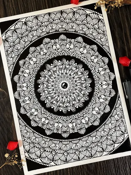 A classic black and white mandala with a yin-yang symbol at its heart, representing the balance I strive to find through my art.
