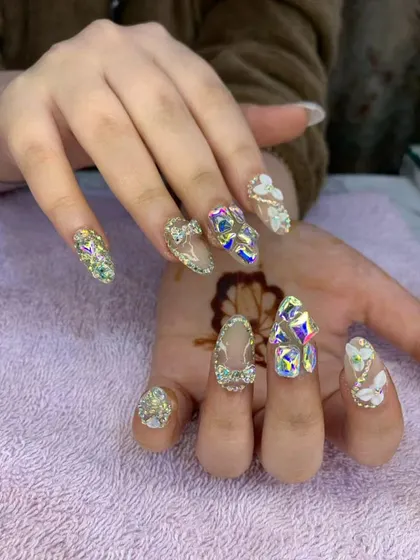 An opulent and glamorous set featuring a mix of 3D sculpted flowers, bows, and an abundance of iridescent crystals. This design is perfect for anyone wanting maximum sparkle and dimension.