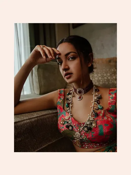 A close-up on the jewelry and makeup for Shanvi's look, showing how accessories are chosen to complement the outfit's color palette and neckline.