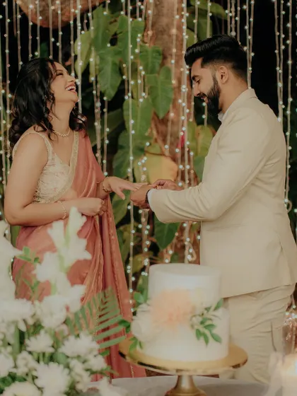 A moment of pure laughter as the groom slips the ring on his fiancée's finger.