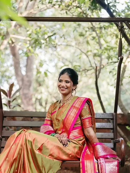 A serene portrait of the bride on a swing, surrounded by lush greenery, capturing a moment of peaceful happiness.
