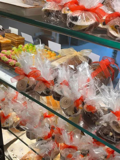 A look inside our Christmas display case, filled with festive goodies like plum cakes, marzipan, and other treats.