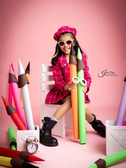 Cool and confident, the birthday girl poses with her giant colorful pencils. I provide fun accessories like these quirky sunglasses to match the theme.