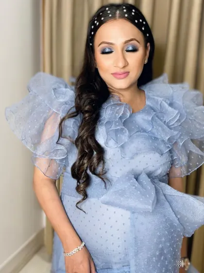 A close-up showing the pregnancy glow, enhanced with a flawless base and soft pink lips.