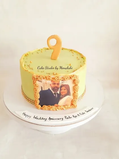 A sweet and simple anniversary cake featuring a framed photo of the happy couple. This no-fondant design is a wonderful way to celebrate nine years of togetherness.