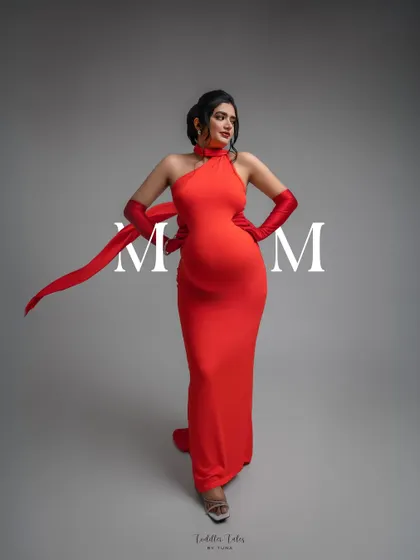 A bold statement of motherhood. The "MOM" overlay on this modern red gown portrait adds a graphic, powerful element, celebrating the title with style.