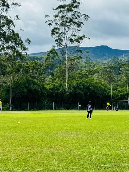 A wide shot of the beautiful ground in Sri Lanka, surrounded by trees and mountains.