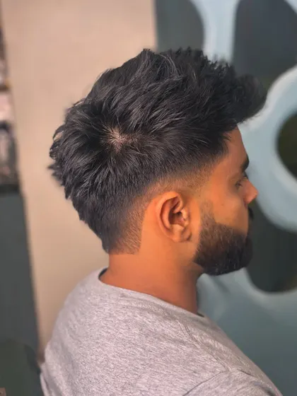 The back view of this textured cut, showing the volume and the clean taper at the neckline that complements the beard.