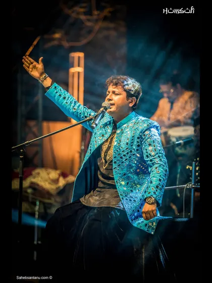 A soulful shot of our lead vocalist, bathed in the glow of the stage lights.