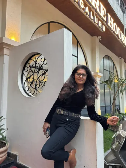 An all-black look featuring a velvet top, black jeans, and a statement belt. This is my go-to for a chic and comfortable evening out.