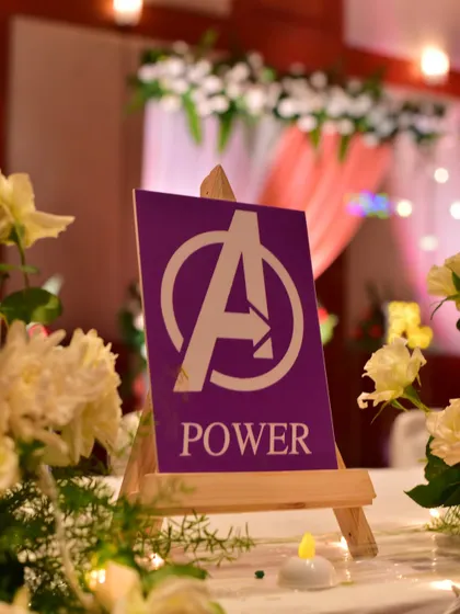 A close-up of an Avengers-themed table sign. It's these little custom details that make a themed event special.
