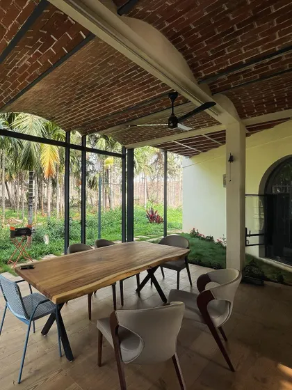 Another view of the farmhouse dining space, showing the beautiful texture of the exposed brick vault. This feature adds immense character and warmth to the room.