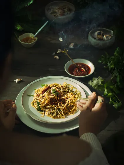 A comforting bowl of chili roasted garlic noodles, captured with steamy, atmospheric lighting. This shot was from a personal project and shows my passion for capturing food that I cook and love myself.