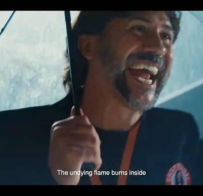 A joyful moment from the East Bengal FC commercial, with a fan celebrating in the rain. The styling captures the raw passion of football supporters.