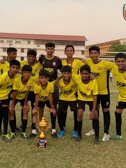 Posing with pride. The U14 squad and their championship trophy, representing Mumbai on a national stage.