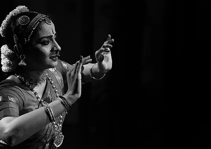 This black and white photograph captures a moment of pure expression, or 'bhava'. Stripped of color, the focus is entirely on the emotion and storytelling through facial gestures.
