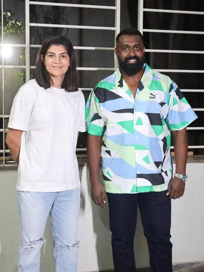 A guest poses with our head coach during the gym's opening celebration.