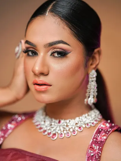Another close-up showing the sharp winged liner and peachy-coral lip color that perfectly complements her skin tone.