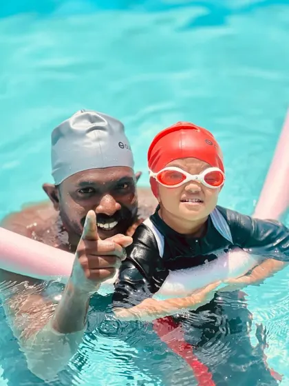 All smiles and encouragement in the pool. Using a pool noodle for support, this toddler is learning to float and kick in a fun, pressure-free environment.