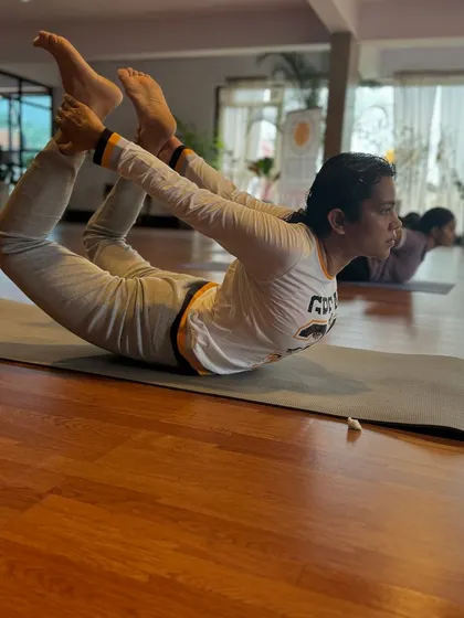 "You are only as young as your spine is flexible." A student demonstrates Dhanurasana (Bow Pose), an excellent backbend for strengthening the back muscles and improving posture.