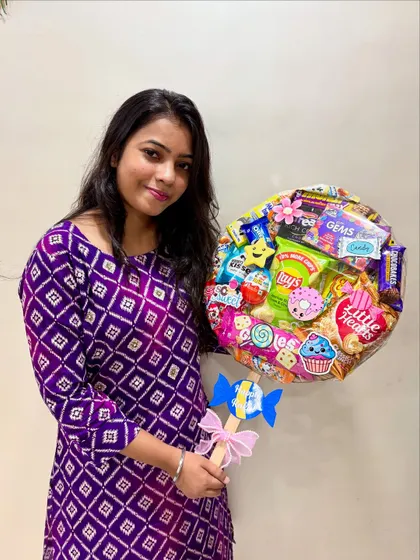 Here I am with a colorful lollipop hamper I made for Rakhi. Every single hamper is assembled by me, and it brings me so much joy to know they'll be part of your special moments.