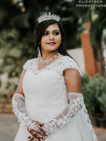 A beautiful portrait of the bride in her detailed lace gown and tiara, looking elegant and poised.