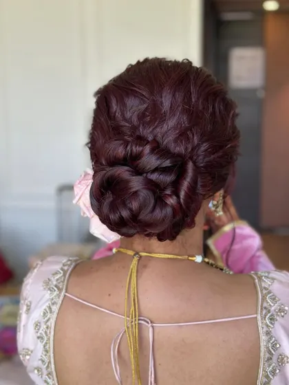 A close-up shot that highlights the texture and twists of this intricate bridal bun.
