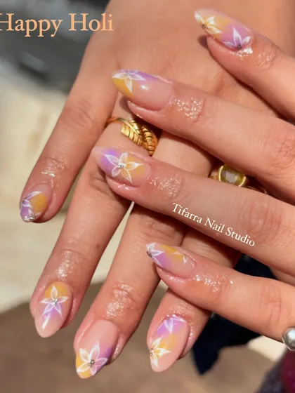 A soft and subtle design perfect for Holi. This look features a pastel ombre base with delicate, hand-drawn floral designs, celebrating the festival of colors in an elegant way.