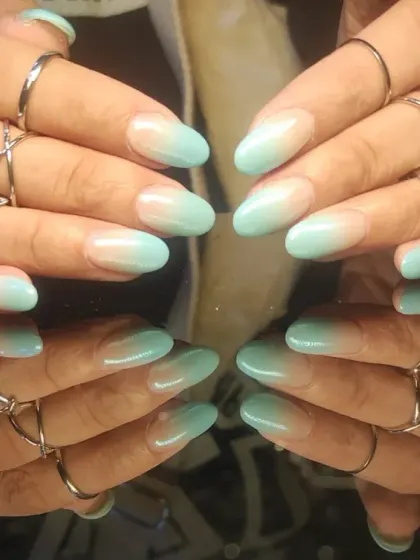 A soft and dreamy mint green ombre, fading gently from a sheer base to a cool pastel tip.