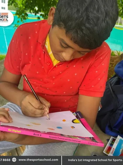 A student carefully works on his drawing, fully engaged in the creative process.