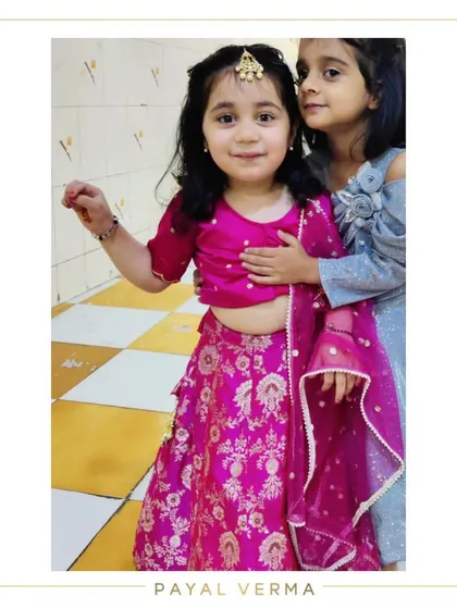 Pretty in pink. Little Zora is dressed in a custom hot pink Banarasi lehenga set for a festive occasion. The rich fabric and vibrant color make this a perfect choice for weddings and parties.
